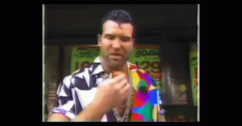 A Man In A Colorful Shirt Is Standing In Front Of A Sign That Says Soda GIF