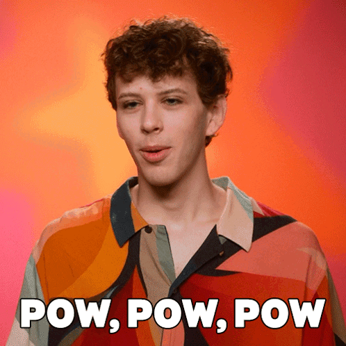 A Man In A Colorful Shirt With The Words Pow Pow Pow Behind Him GIF