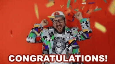 A Man In A Colorful Suit Is Celebrating With Confetti Falling Around Him And The Words Congratulations ! GIF