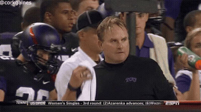 A Man In A Cork Gaines Jersey Watches A Football Game On Espn GIF