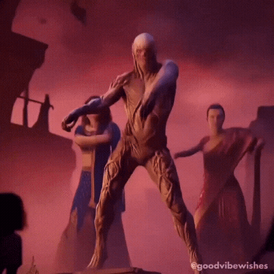 A Man In A Costume Is Dancing With A Group Of Women In Saris . GIF