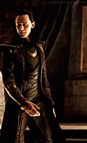 A Man In A Costume Is Holding A Knife In His Hand . GIF
