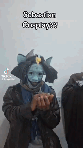A Man In A Costume Is Holding Something In His Hands And Says Sebastian Cosplay . GIF