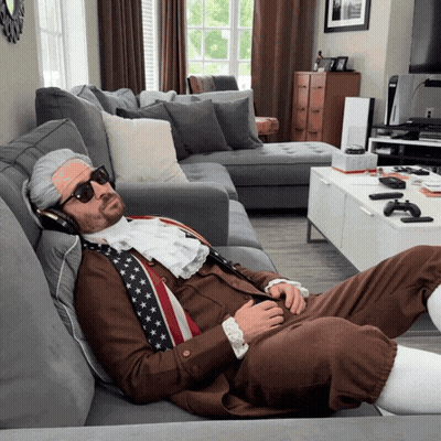 A Man In A Costume Is Laying On A Couch GIF