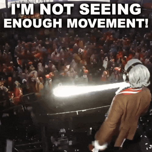 A Man In A Costume Is Standing In Front Of A Crowd With The Words I 'M Not Seeing Enough Movement Above Him GIF