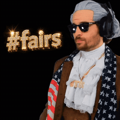 A Man In A Costume With A #Fairs Sign Behind Him GIF