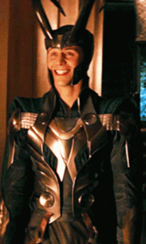 A Man In A Costume With Horns On His Head Is Smiling GIF