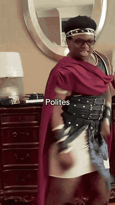 A Man In A Costume With Polites Written On The Bottom Right GIF