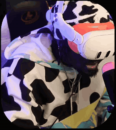 A Man In A Cow Print Hoodie Is Wearing A Virtual Reality Headset . GIF