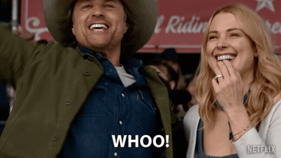 A Man In A Cowboy Hat And A Woman In Overalls Are Laughing And The Man Is Saying Whoo! GIF