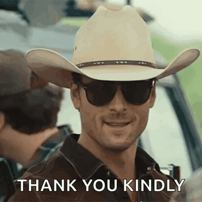A Man In A Cowboy Hat And Sunglasses Is Smiling And Saying Thank You Kindly . GIF