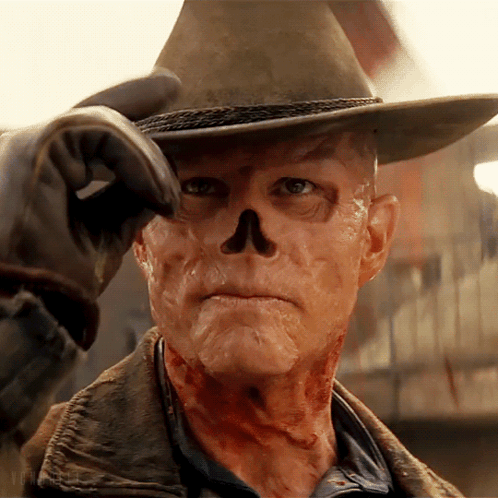 A Man In A Cowboy Hat Has A Skull On His Face GIF