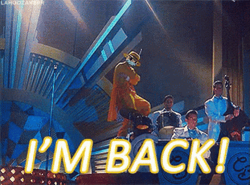 A Man In A Cowboy Hat Is Dancing In Front Of A Band With The Words I 'M Back Written In Yellow GIF
