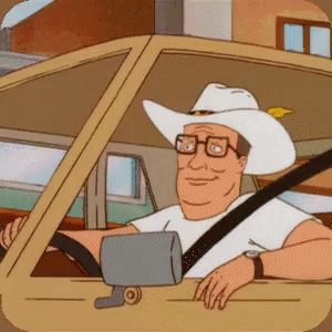 A Man In A Cowboy Hat Is Driving A Car GIF