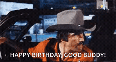 A Man In A Cowboy Hat Is Driving A Car And Saying `` Happy Birthday , Good Buddy '' . GIF