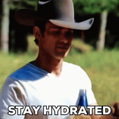 A Man In A Cowboy Hat Is Holding A Bottle Of Beer And Says Stay Hydrated GIF