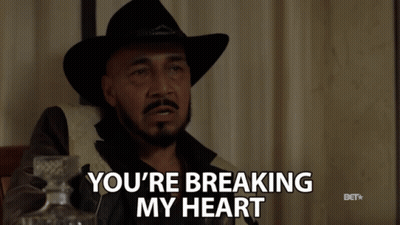 A Man In A Cowboy Hat Is Holding A Glass Of Whiskey And Says You 'Re Breaking My Heart GIF