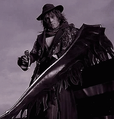 A Man In A Cowboy Hat Is Holding A Gun And A Large Sword GIF