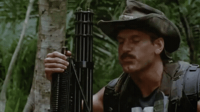 A Man In A Cowboy Hat Is Holding A Gun And The Name Jesse Ventura Is On The Bottom Right GIF