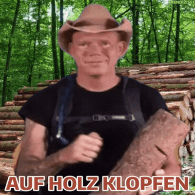 A Man In A Cowboy Hat Is Holding A Log In Front Of A Pile Of Logs With The Words Auf Holz Klopfen Above Him GIF