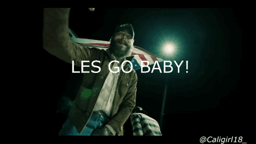 A Man In A Cowboy Hat Is Holding An American Flag And Says Les Go Baby GIF