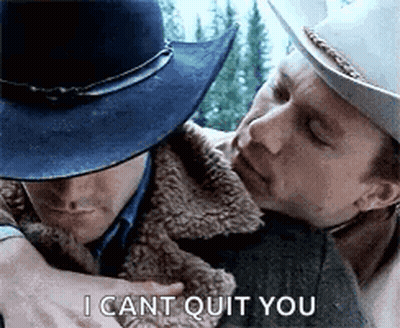 A Man In A Cowboy Hat Is Hugging Another Man In A Fur Coat . GIF
