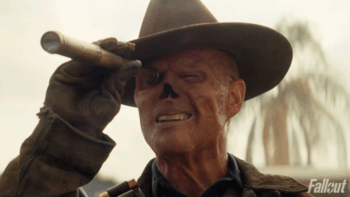 A Man In A Cowboy Hat Is Looking Through A Telescope With Fallout Written In The Corner GIF