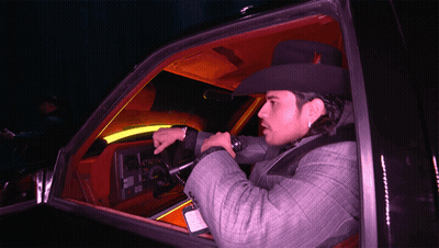 A Man In A Cowboy Hat Is Sitting In A Car GIF