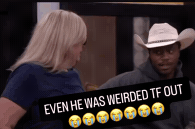 A Man In A Cowboy Hat Is Sitting Next To A Woman With A Sign That Says Even He Was Weirded Out GIF