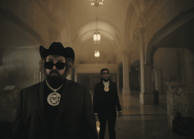 A Man In A Cowboy Hat Is Smoking A Cigarette GIF
