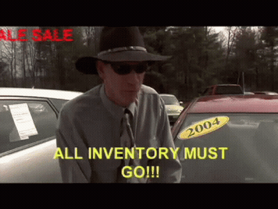 A Man In A Cowboy Hat Is Standing In Front Of A Car With A 2004 Sticker On It GIF