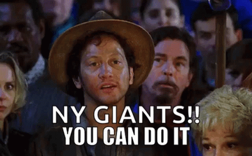 A Man In A Cowboy Hat Is Standing In Front Of A Crowd Of People And Saying Ny Giants ! You Can Do It . GIF