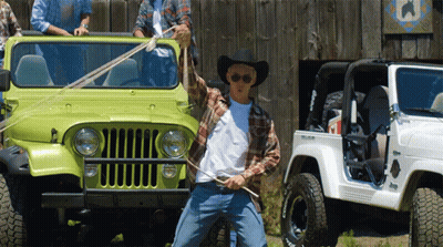 A Man In A Cowboy Hat Is Standing In Front Of A Jeep GIF