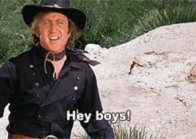 A Man In A Cowboy Hat Is Standing In The Dirt And Saying Hey Boys GIF