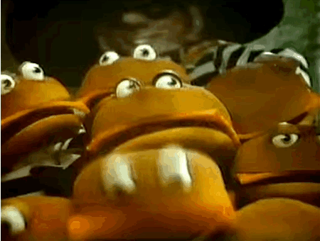 A Man In A Cowboy Hat Is Standing Next To A Bunch Of Frogs With Big Eyes . GIF