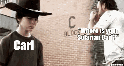 A Man In A Cowboy Hat Is Standing Next To Another Man In Front Of A Brick Building . GIF