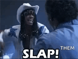 A Man In A Cowboy Hat Is Talking To Another Man In A Blue Shirt And Says `` Slap Them '' . GIF