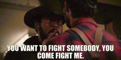 A Man In A Cowboy Hat Is Talking To Another Man In A Plaid Shirt .. GIF