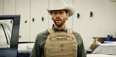 A Man In A Cowboy Hat Is Wearing A Vest That Says Ranger GIF