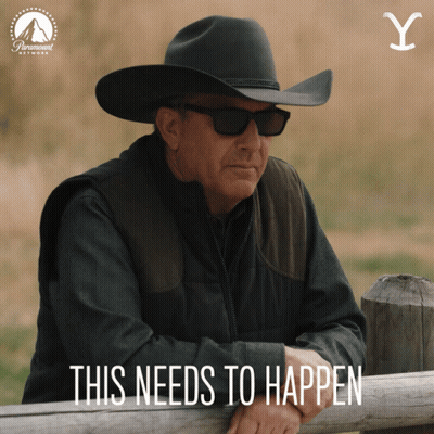 A Man In A Cowboy Hat Leans On A Wooden Fence With The Words This Needs To Happen GIF