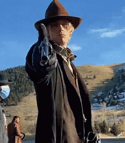 A Man In A Cowboy Hat Pointing A Gun GIF