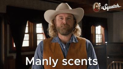 A Man In A Cowboy Hat Says Manly Scents In Front Of A Sign That Says The Squatch GIF