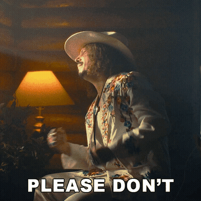 A Man In A Cowboy Hat Says Please Don 'T In Front Of A Lamp GIF