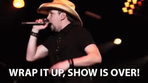 A Man In A Cowboy Hat Singing Into A Microphone With The Words " Wrap It Up Show Is Over " Behind Him GIF