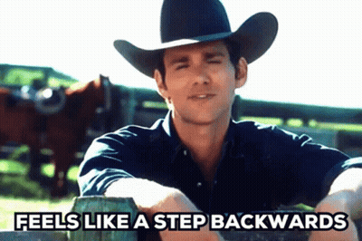 A Man In A Cowboy Hat Sits On A Fence With The Words Feels Like A Step Backwards GIF