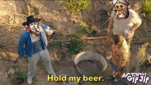 A Man In A Cowboy Hat Stands In The Dirt With The Words Hold My Beer GIF