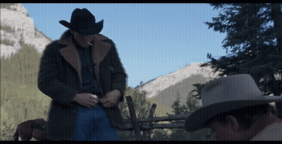 A Man In A Cowboy Hat Stands Next To Another Man GIF