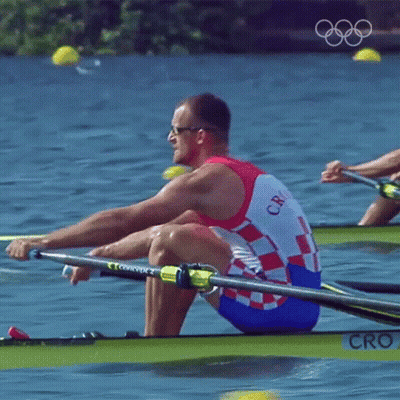 A Man In A Croatia Uniform Is Rowing A Boat In The Water GIF