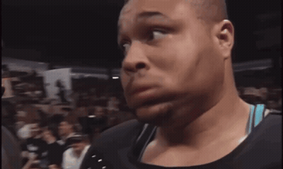 A Man In A Crowd Holds A Sign That Says Undertaker Rules GIF
