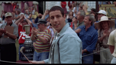 A Man In A Crowd Holds A Trophy With The Number 1000 On It GIF